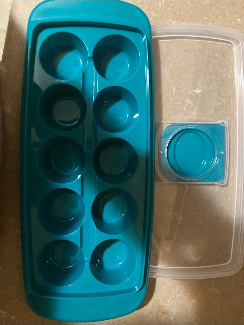 Assorted ice cube trays, scooper and storage